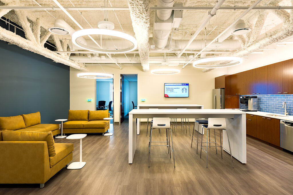 Open collaboration room with a wall display and shared work table